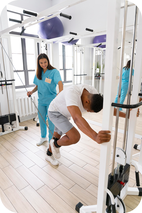 A male patient with a back injury is guided by a female physiotherapist through an exercise using a low bar to improve mobility and strength.